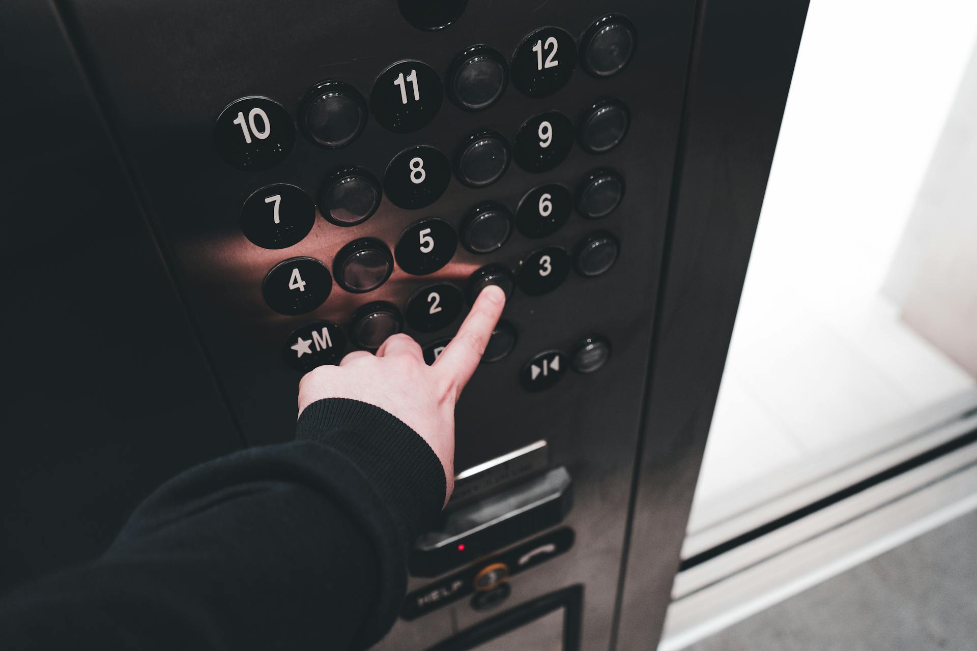 A person pressing a button in the elevator | Source: Pexels