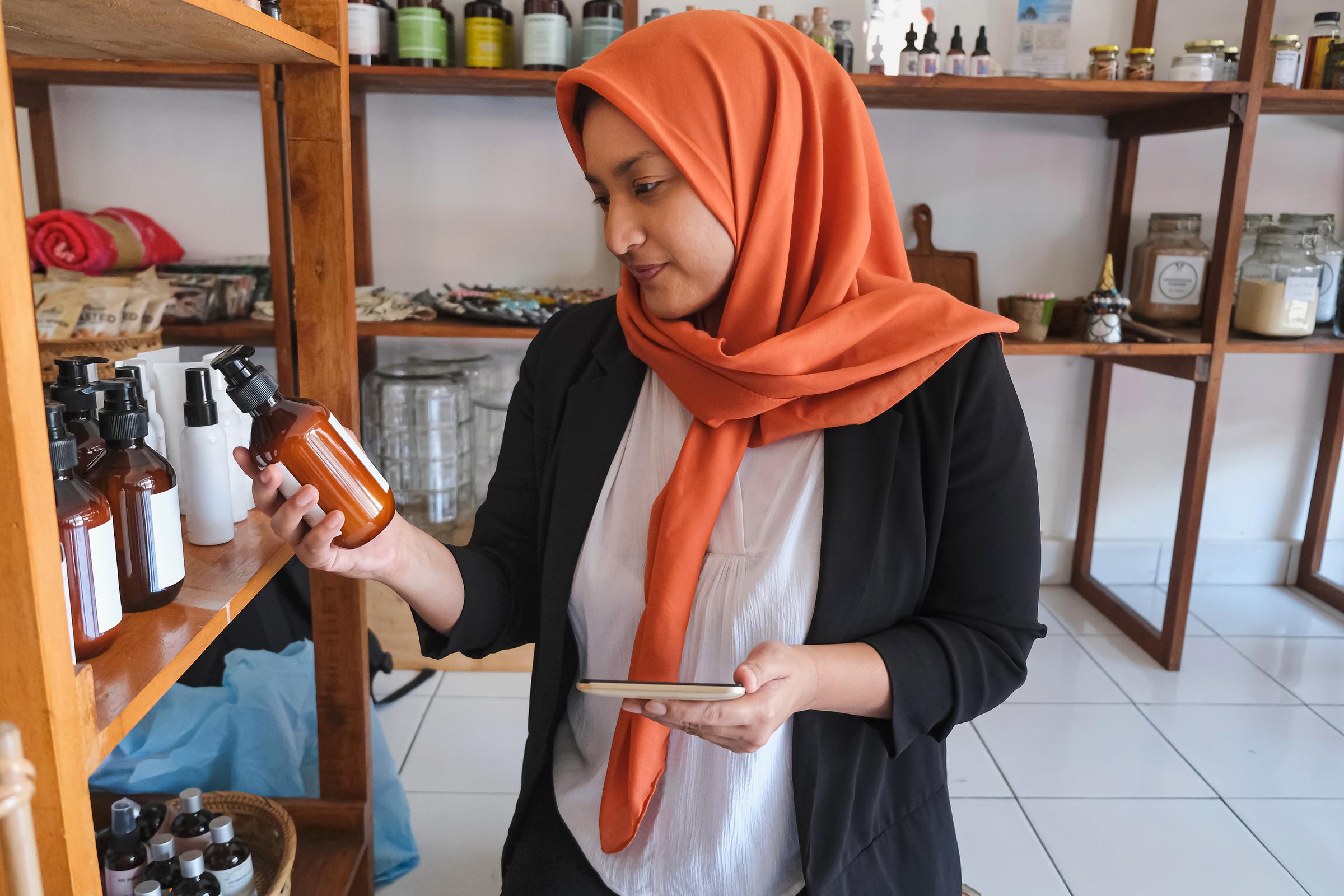 A woman checking the expiry date of a skincare product | Source: Getty Images