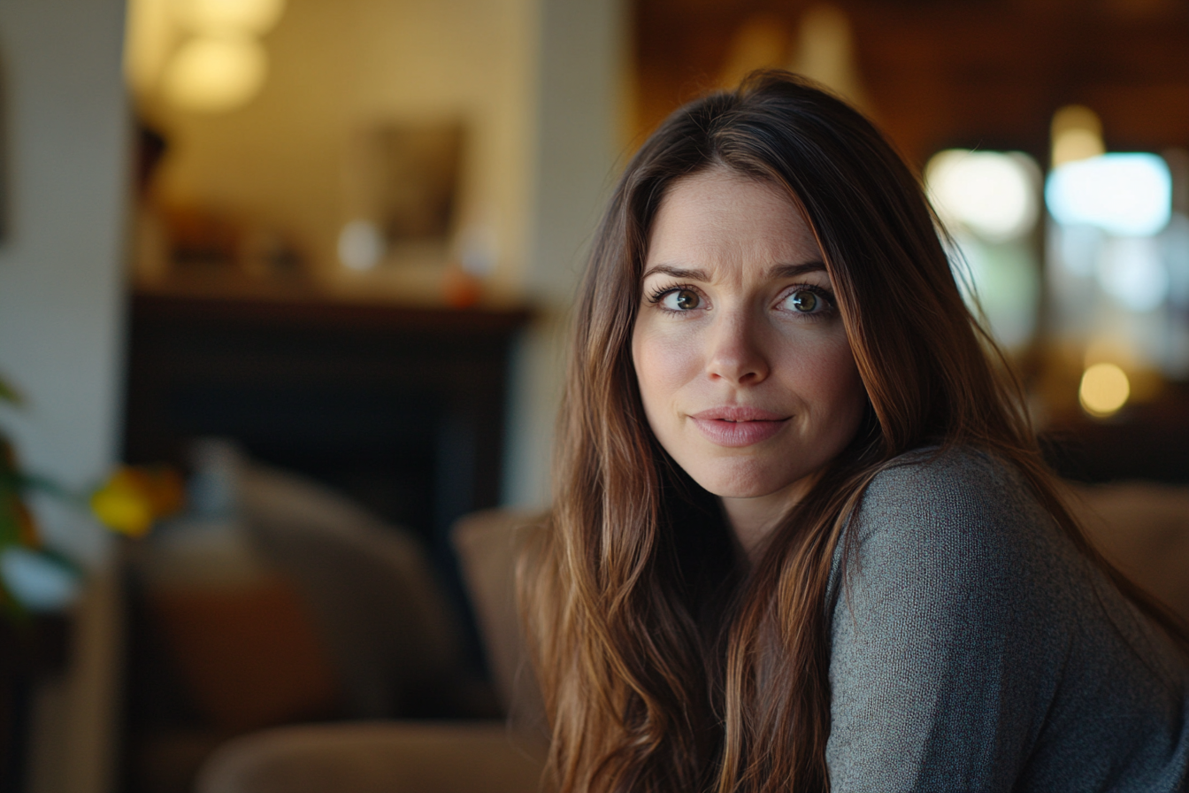 A mildly concerned woman in her living room | Source: No source