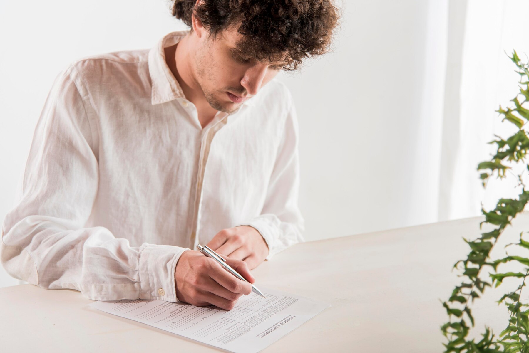 A man signing a document | Source: Freepik