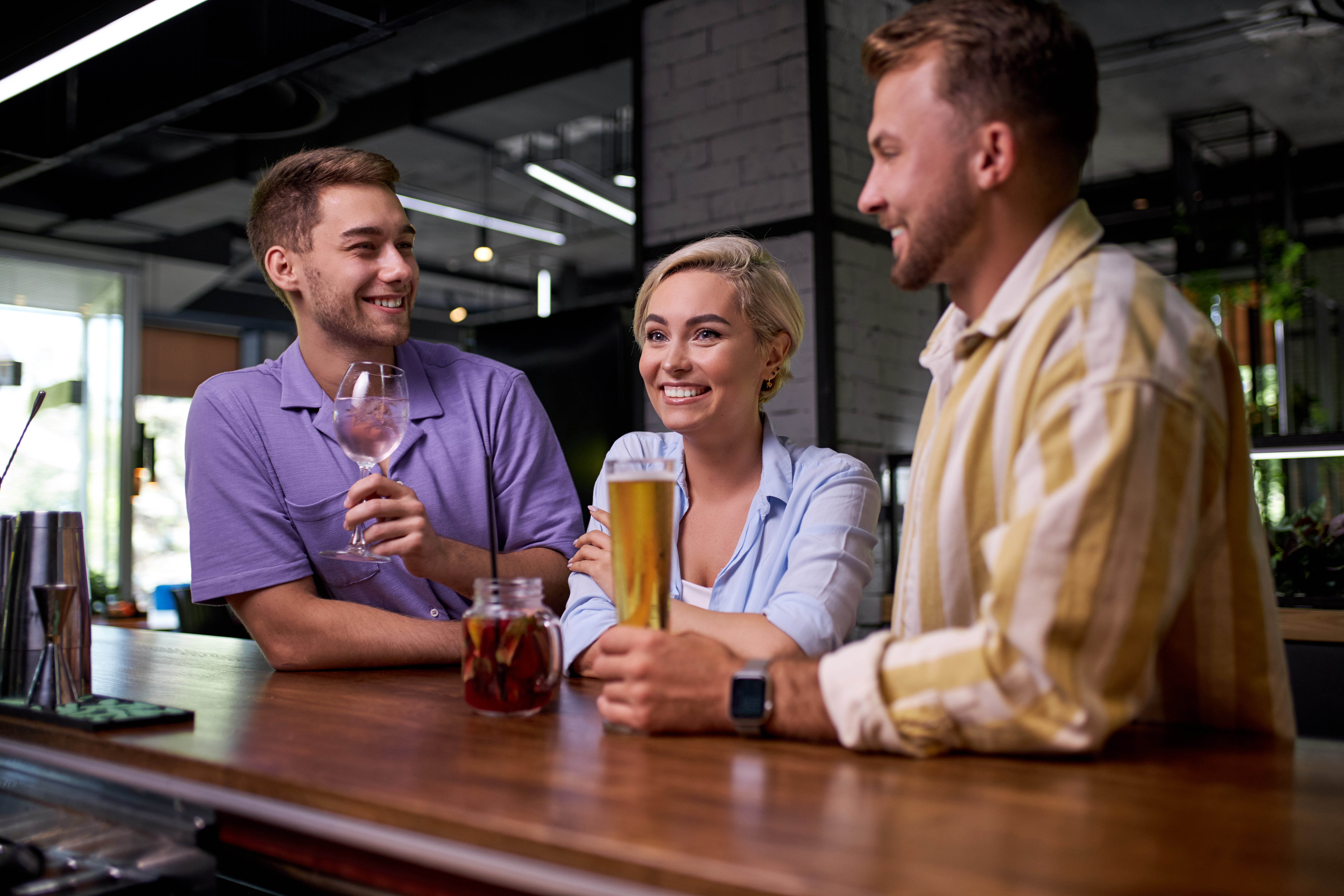 Two guys with a woman between them | Source: Shutterstock