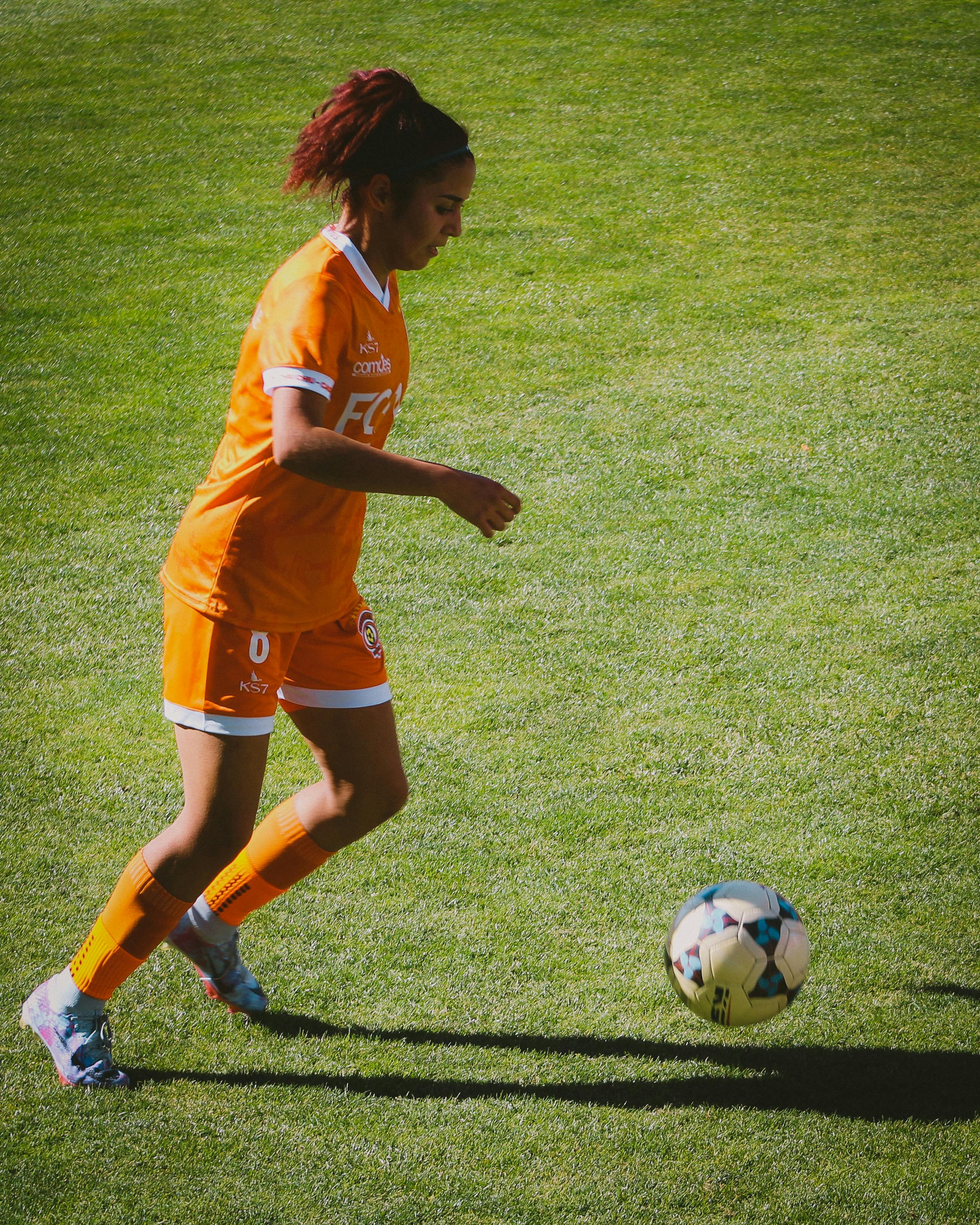 Person playing football | Source: Pexels