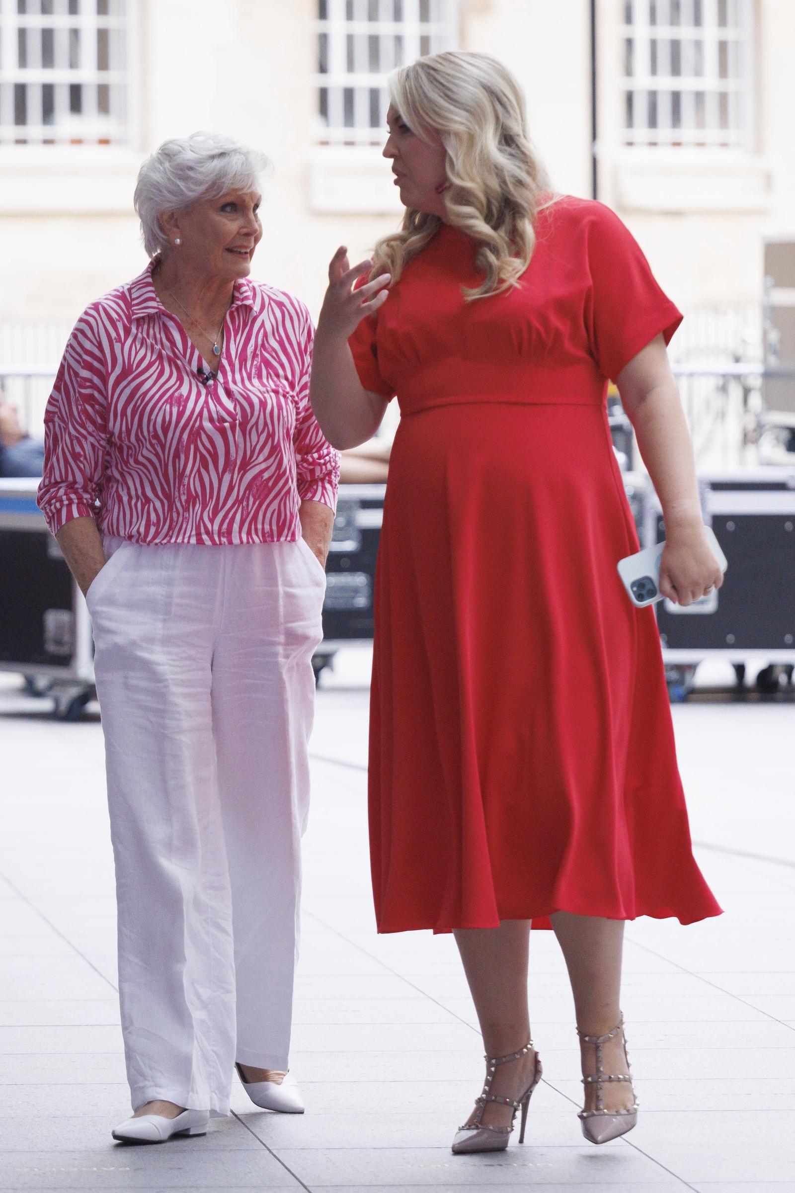 Star support! Davies shares a lively exchange with broadcasting legend Angela Rippon as the pair are spotted leaving BBC Broadcasting House in London on 4 August 2023. The outing comes just hours after Rippon was revealed as a contestant for the then-upcoming "Strictly Come Dancing" series — and Davies is clearly there to cheer her on.