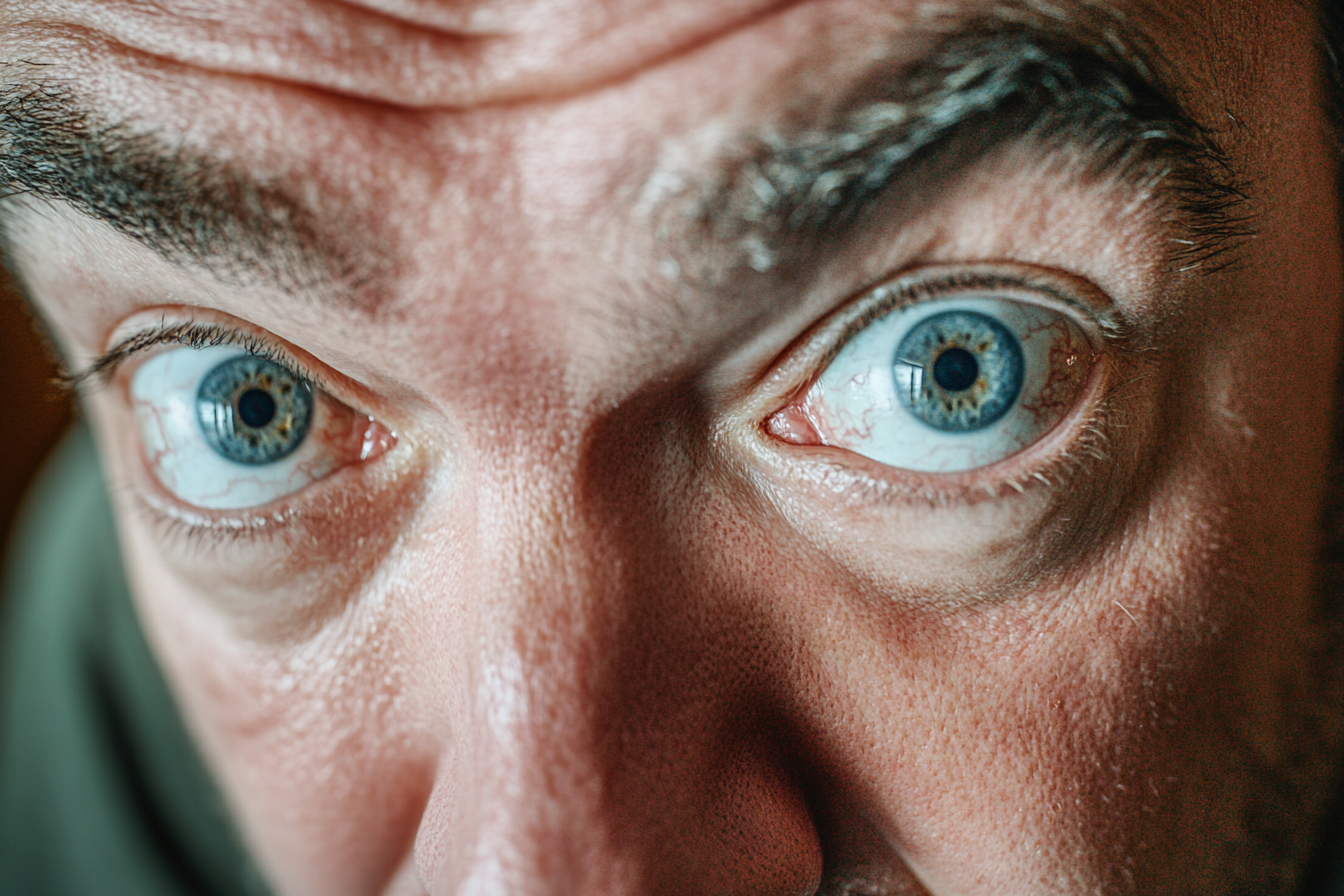 A man staring at someone with wide eyes | Source: No source