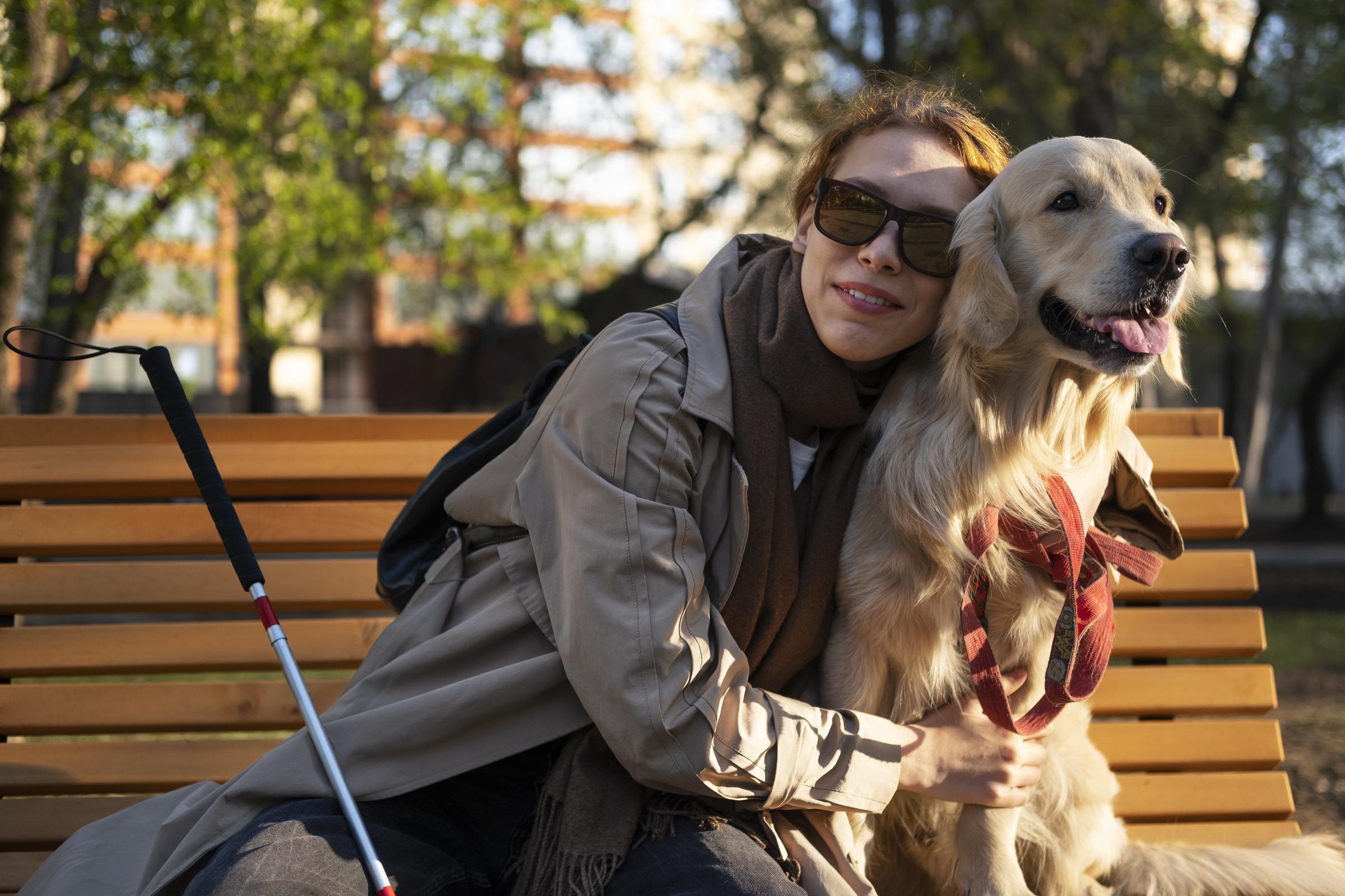 A blind woman hugging a dog | Source: No source