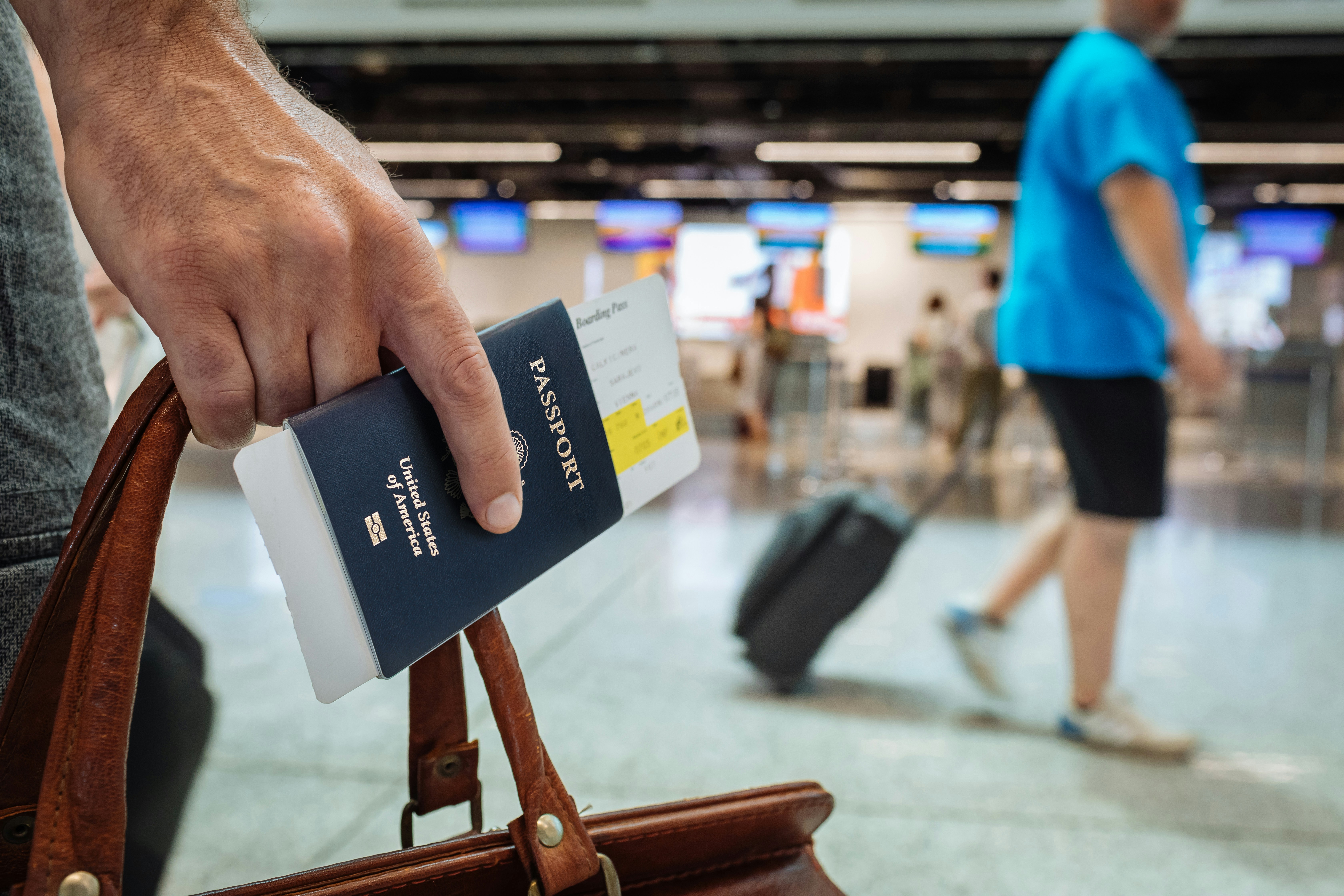 A  person holding a passport at an airport | Source: Unsplash