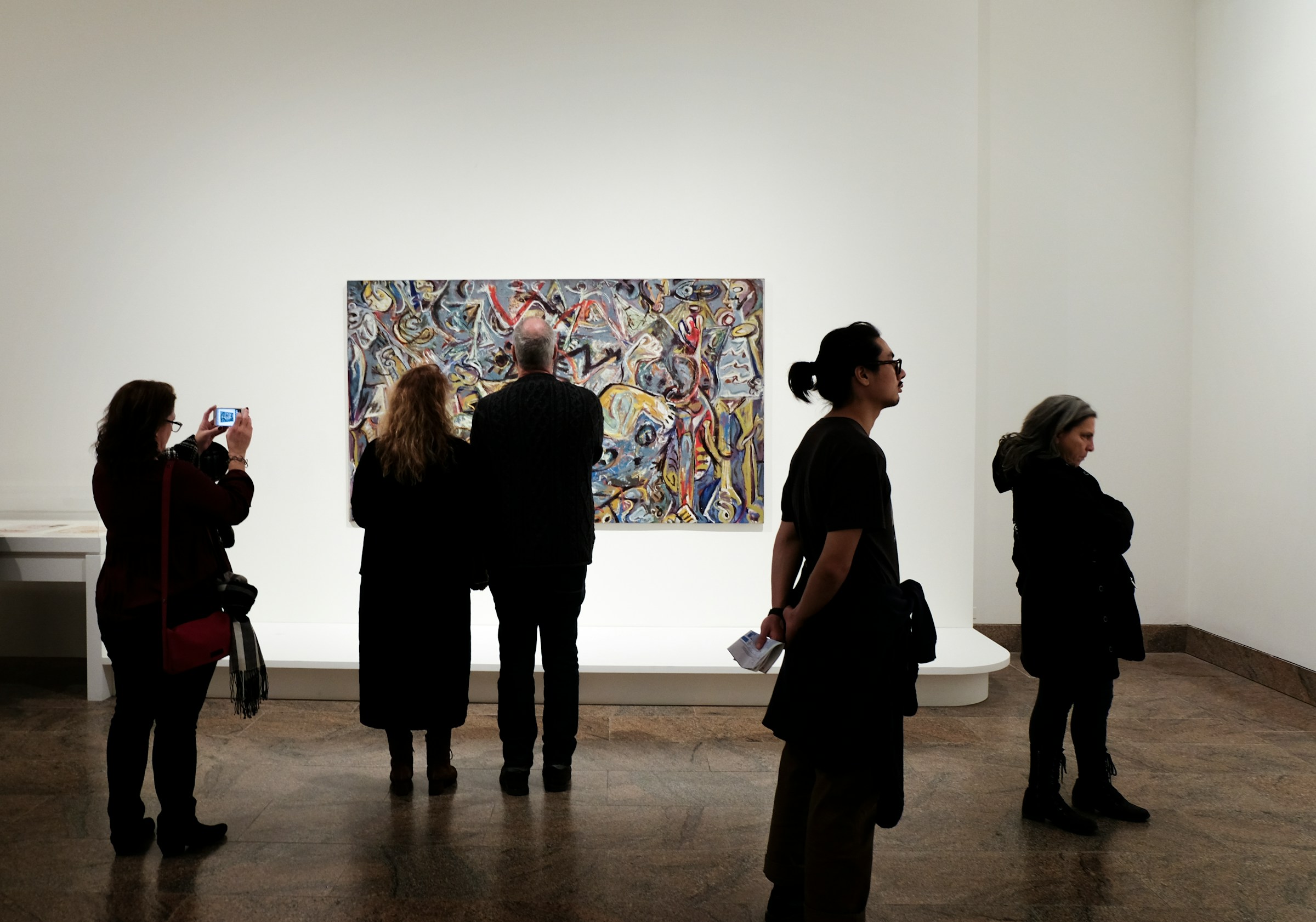 People standing in front of a painting | Source: Unsplash