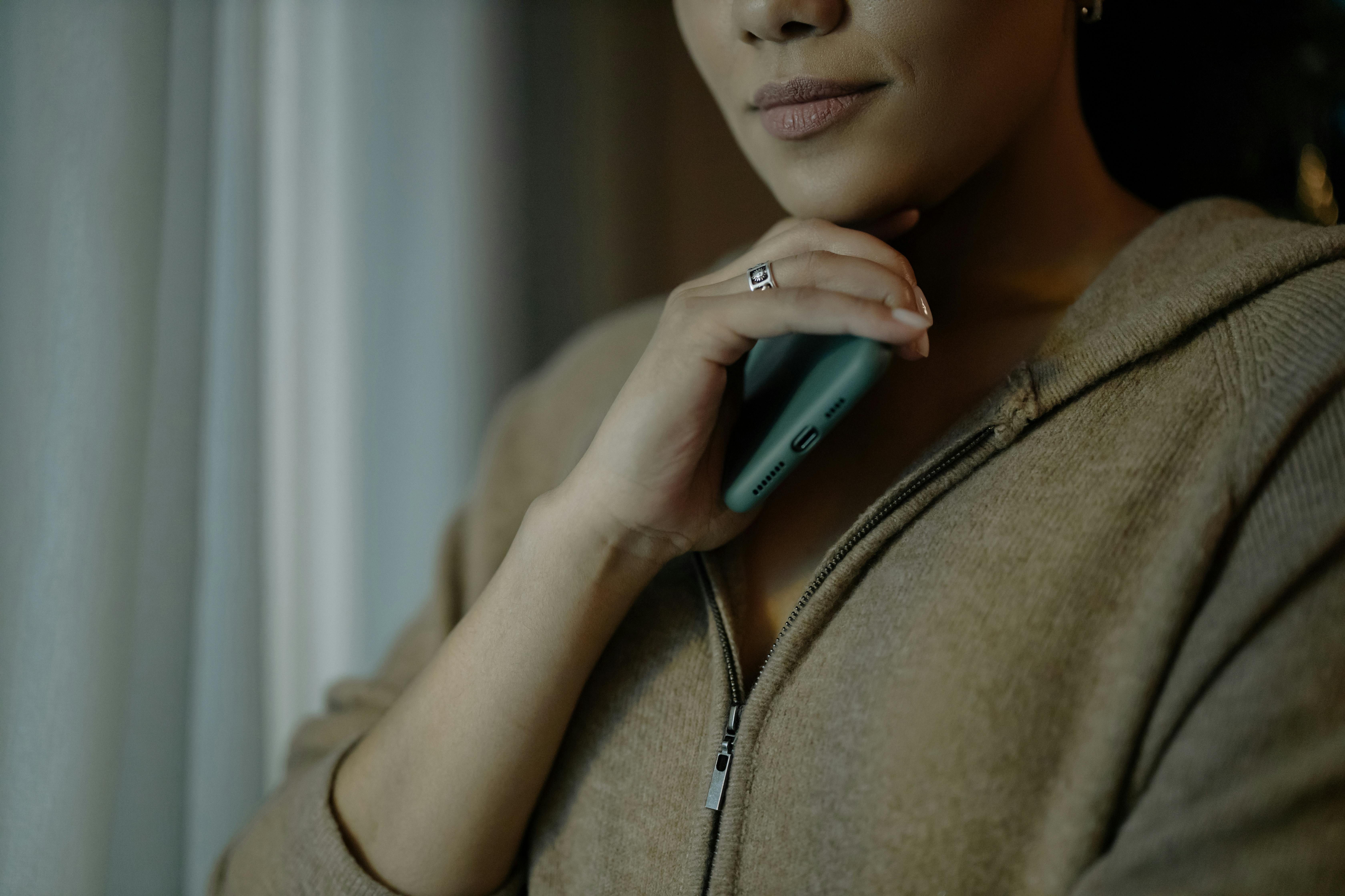 A woman holding a phone | Source: Pexels