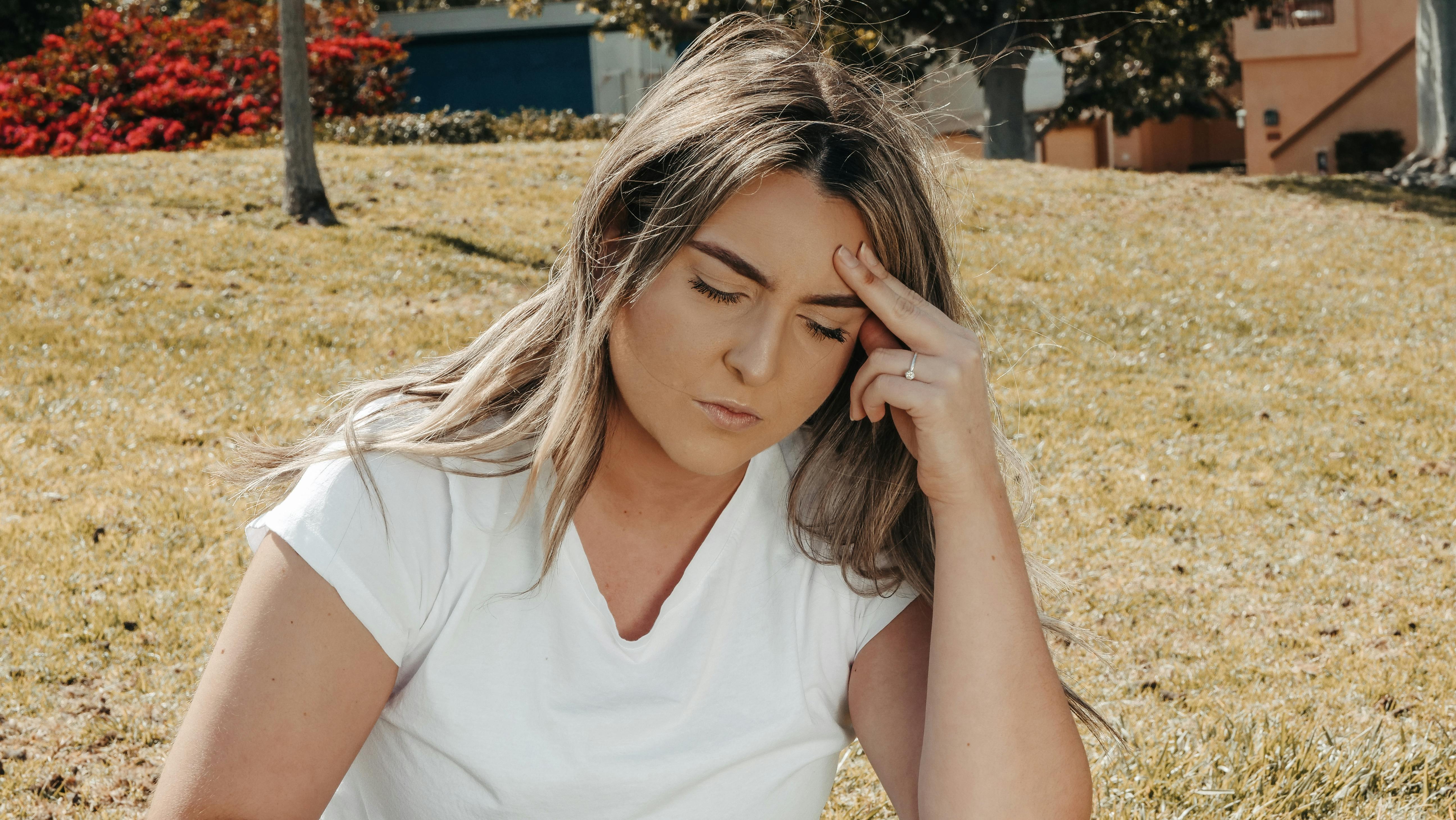 Woman in pain holding head