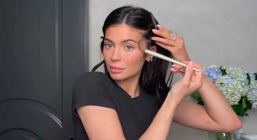 Kylie Jenner doing her classic beauty routine from a video dated April 6, 2023. | Source: YouTube/Vogue